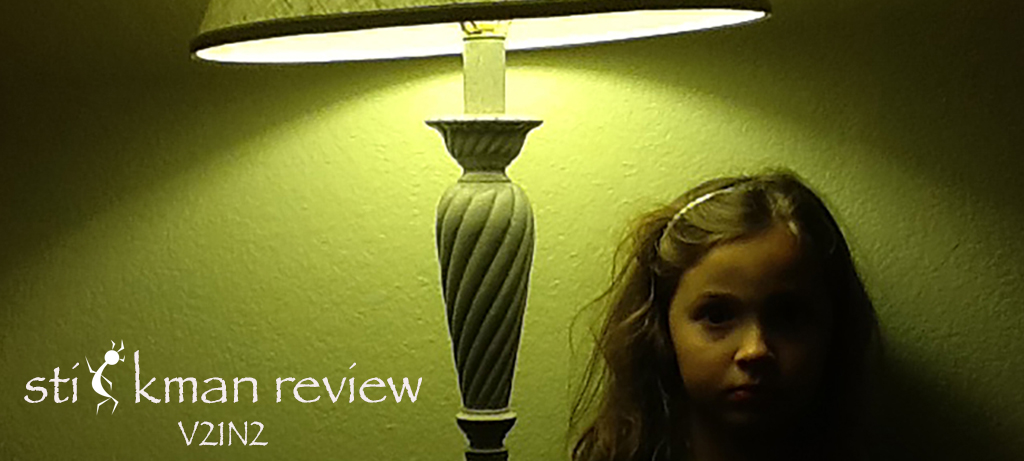 Little girl in shadow under lighted lamp